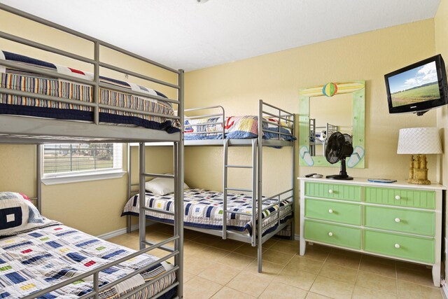 115 Southwind Dr, Surfside Beach, TX 77541 - bedroom with tile patterned flooring and baseboards
