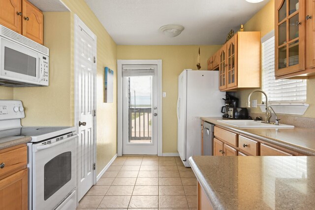 115 Southwind Dr, Surfside Beach, TX 77541 - kitchen featuring white appliances, glass insert cabinets, and light tile patterned flooring