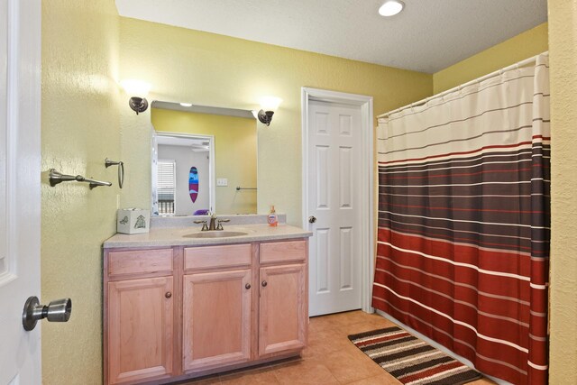 115 Southwind Dr, Surfside Beach, TX 77541 - bathroom featuring vanity, tile patterned floors, a textured wall, and a shower with shower curtain