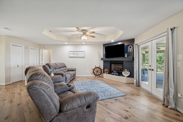 527 Caney Creek Dr, Livingston, TX 77351 - living area featuring french doors, a raised ceiling, light wood-style flooring, a ceiling fan, and recessed lighting