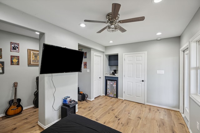 527 Caney Creek Dr, Livingston, TX 77351 - bedroom with light wood finished floors, bar, recessed lighting, ceiling fan, and refrigerator