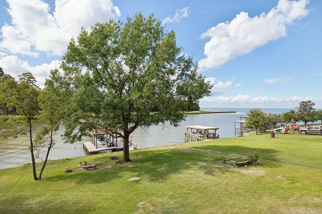 527 Caney Creek Dr, Livingston, TX 77351 - view of grassy yard featuring a dock, a water view, and boat lift