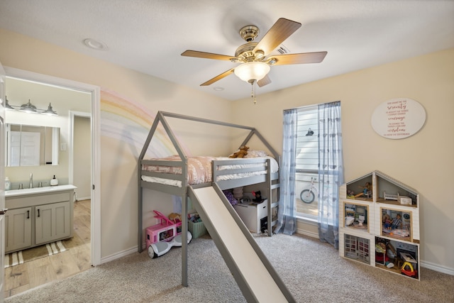 527 Caney Creek Dr, Livingston, TX 77351 - bedroom with light carpet, a ceiling fan, and ensuite bath