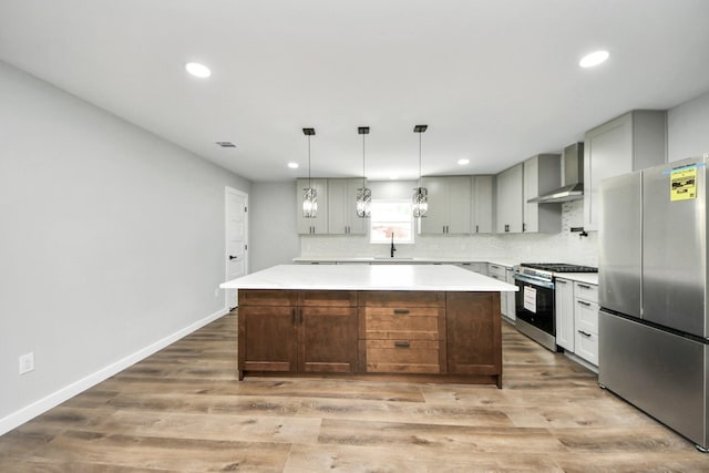 1218 Des Jardines St, Houston, TX 77023 - kitchen with appliances with stainless steel finishes, wall chimney exhaust hood, light countertops, light wood-style floors, and recessed lighting