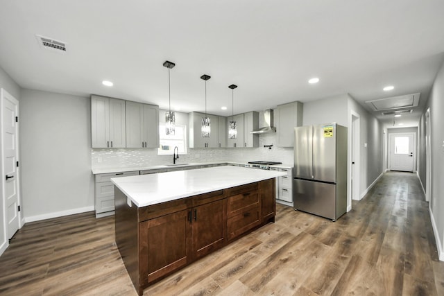 1218 Des Jardines St, Houston, TX 77023 - kitchen with freestanding refrigerator, wall chimney exhaust hood, light countertops, backsplash, and recessed lighting