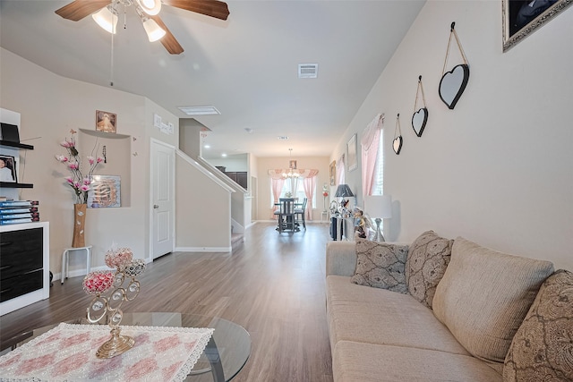 3638 Bright Moon Ct, Katy, TX 77449 - living room with a chandelier, stairs, wood finished floors, and a ceiling fan