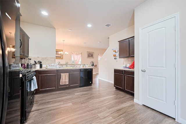 3638 Bright Moon Ct, Katy, TX 77449 - kitchen with black appliances, a peninsula, dark brown cabinets, tasteful backsplash, and recessed lighting