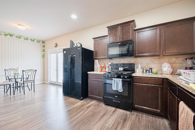 3638 Bright Moon Ct, Katy, TX 77449 - kitchen featuring black appliances, dark brown cabinets, light wood finished floors, and decorative backsplash