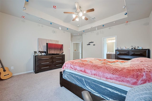 3638 Bright Moon Ct, Katy, TX 77449 - bedroom with a tray ceiling, light carpet, ensuite bathroom, and a ceiling fan