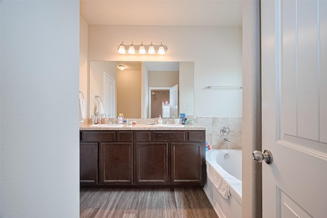 3638 Bright Moon Ct, Katy, TX 77449 - bathroom with a garden tub, double vanity, and wood finished floors