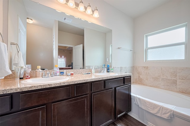 3638 Bright Moon Ct, Katy, TX 77449 - bathroom with double vanity and a garden tub