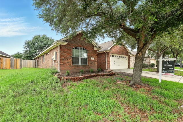 303 Burris Park Dr, Spring, TX 77373 - view of front of property with brick siding, driveway, and a garage
