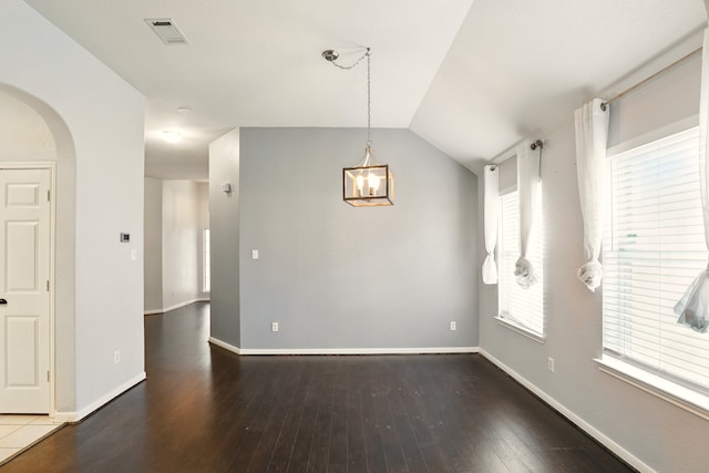 303 Burris Park Dr, Spring, TX 77373 - unfurnished dining area featuring arched walkways, hardwood / wood-style floors, a chandelier, and vaulted ceiling
