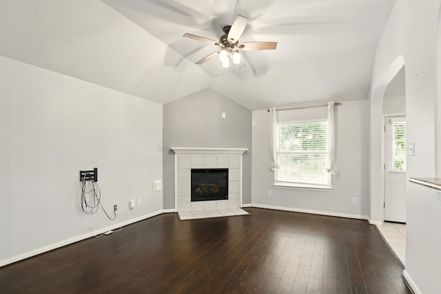 303 Burris Park Dr, Spring, TX 77373 - unfurnished living room with a tile fireplace, a ceiling fan, hardwood / wood-style flooring, and vaulted ceiling