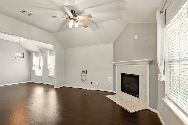 303 Burris Park Dr, Spring, TX 77373 - unfurnished living room featuring vaulted ceiling, a ceiling fan, a tile fireplace, dark wood-style floors, and plenty of natural light
