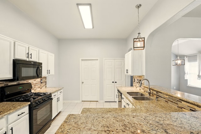 303 Burris Park Dr, Spring, TX 77373 - kitchen featuring black appliances, decorative backsplash, light tile patterned floors, light stone counters, and white cabinetry