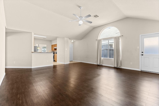2306 Urban Forest Ct, Spring, TX 77386 - unfurnished living room featuring ceiling fan, vaulted ceiling, healthy amount of natural light, and dark wood finished floors