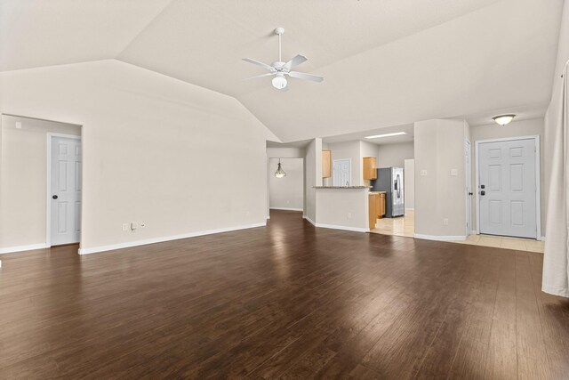 2306 Urban Forest Ct, Spring, TX 77386 - unfurnished living room featuring a ceiling fan, vaulted ceiling, and wood finished floors