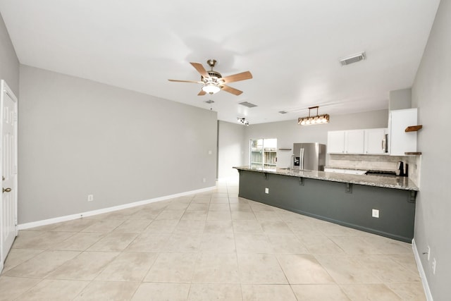 2214 Naomi St, Houston, TX 77054 - kitchen with stainless steel fridge with ice dispenser, a peninsula, ceiling fan, white cabinets, and a kitchen bar
