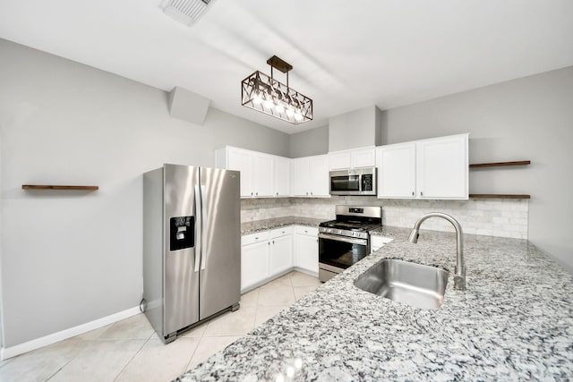 2214 Naomi St, Houston, TX 77054 - kitchen with appliances with stainless steel finishes, open shelves, backsplash, light tile patterned floors, and white cabinetry