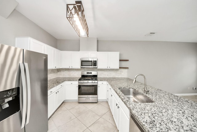 2214 Naomi St, Houston, TX 77054 - kitchen with appliances with stainless steel finishes, tasteful backsplash, light stone countertops, and white cabinetry