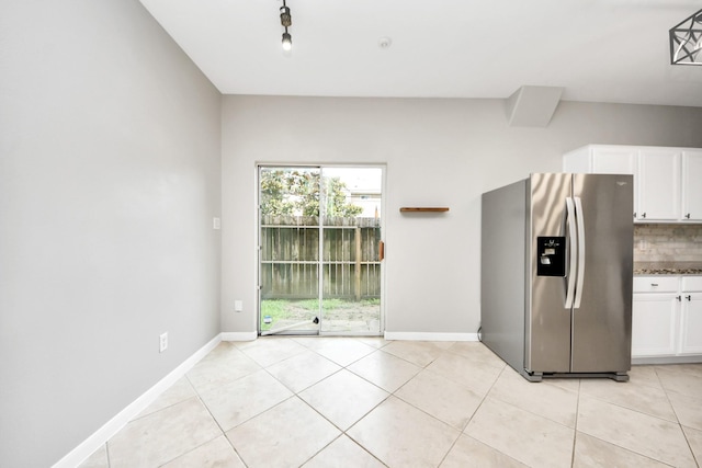2214 Naomi St, Houston, TX 77054 - kitchen featuring stainless steel fridge with ice dispenser, white cabinetry, light tile patterned floors, and decorative backsplash