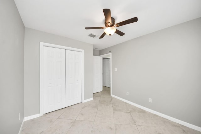 2214 Naomi St, Houston, TX 77054 - unfurnished bedroom with a closet, light tile patterned flooring, and a ceiling fan