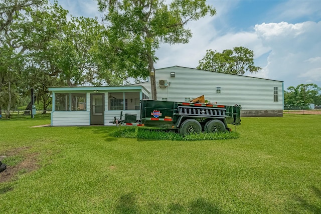 1725 County Road 244e, Brazoria, TX 77422 - rear view of house with a sunroom and a yard