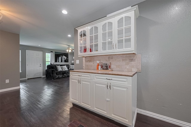 1725 County Road 244e, Brazoria, TX 77422 - kitchen with glass insert cabinets, decorative backsplash, a ceiling fan, white cabinets, and light countertops