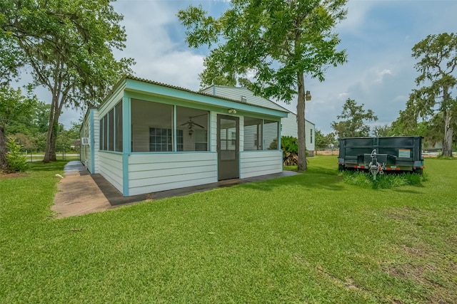 1725 County Road 244e, Brazoria, TX 77422 - back of property with a sunroom, a lawn, and a metal roof