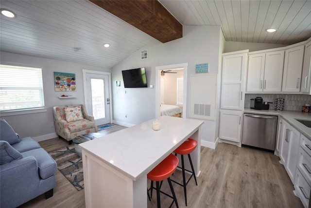 4022 3rd St, Galveston, TX 77554 - kitchen featuring stainless steel dishwasher, open floor plan, a breakfast bar area, light wood-style flooring, and wood ceiling