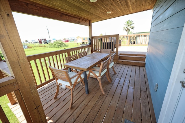4022 3rd St, Galveston, TX 77554 - wooden deck with outdoor dining space and a lawn