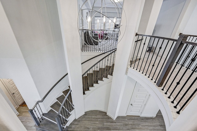11314 Cosmopolitan Dr, Cypress, TX 77433 - stairs featuring wood finished floors, a towering ceiling, and a chandelier