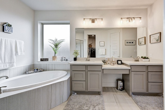 11314 Cosmopolitan Dr, Cypress, TX 77433 - full bathroom featuring double vanity, a bath, and a shower with door