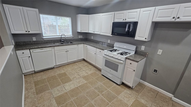 5927 Belarbor St, Houston, TX 77033 - kitchen featuring white appliances, white cabinets, and light stone finish floors