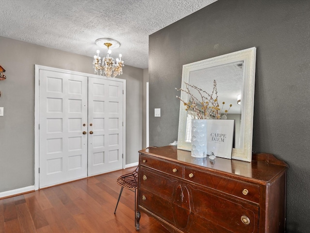 16434 Heatherdale Dr, Houston, TX 77059 - entryway with a chandelier, wood finished floors, and a textured ceiling