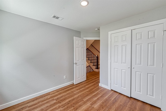 8125 Eastover St Unit Ab, Houston, TX 77028 - unfurnished bedroom with light wood-style floors and a closet