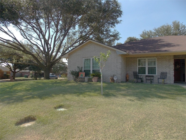 1501 E Pecan St, Brenham, TX 77833 - view of property exterior featuring brick siding and a lawn