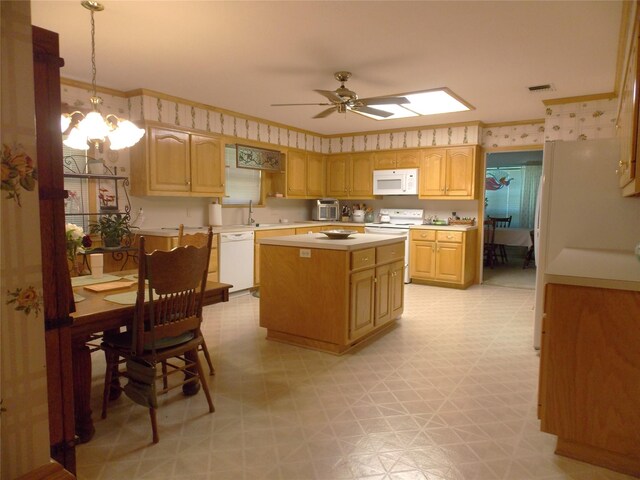 1501 E Pecan St, Brenham, TX 77833 - kitchen featuring white appliances, light flooring, light countertops, a center island, and ceiling fan