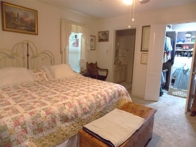 1501 E Pecan St, Brenham, TX 77833 - bedroom featuring a spacious closet, light colored carpet, a closet, and a ceiling fan