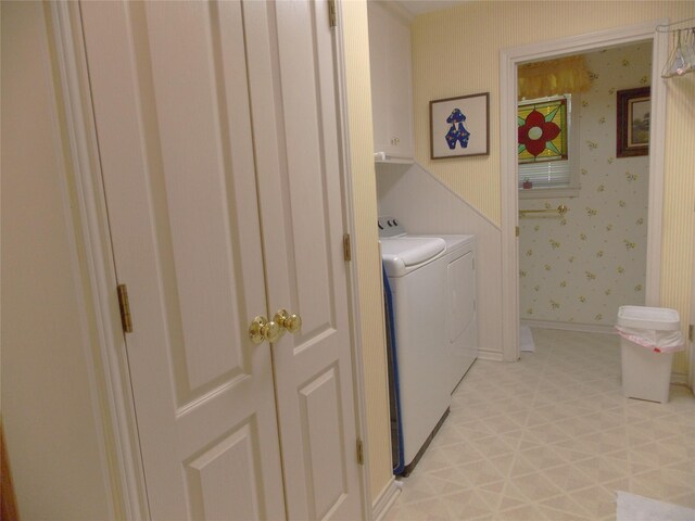 1501 E Pecan St, Brenham, TX 77833 - washroom with cabinet space, separate washer and dryer, and wallpapered walls