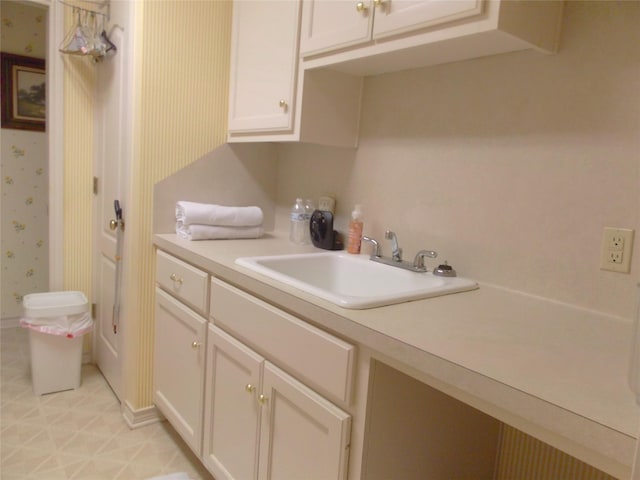 1501 E Pecan St, Brenham, TX 77833 - kitchen featuring light countertops, wallpapered walls, white cabinetry, and light flooring