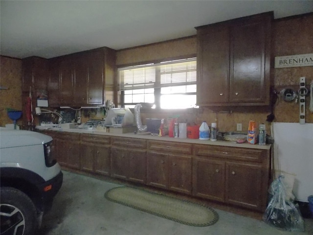 1501 E Pecan St, Brenham, TX 77833 - kitchen with light countertops, concrete flooring, and brown cabinetry