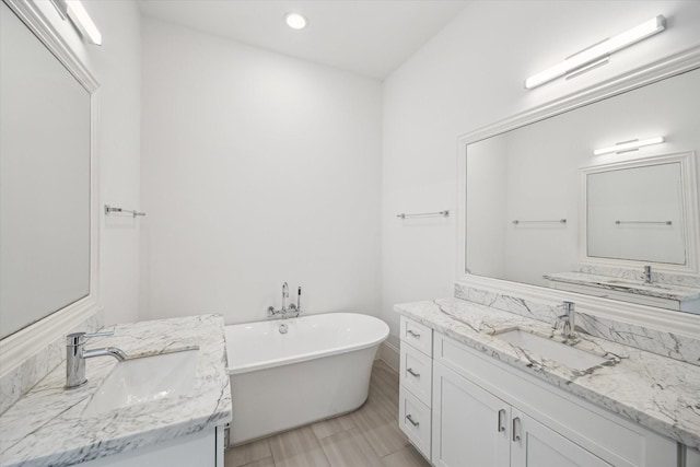 2509 Dorrington Blvd Unit B, Houston, TX 77030 - full bath featuring two vanities, a soaking tub, and recessed lighting