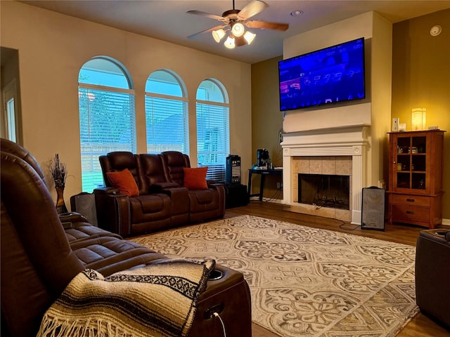 913 S Belle Dr, Angleton, TX 77515 - living area featuring a ceiling fan, wood finished floors, healthy amount of natural light, and a tiled fireplace