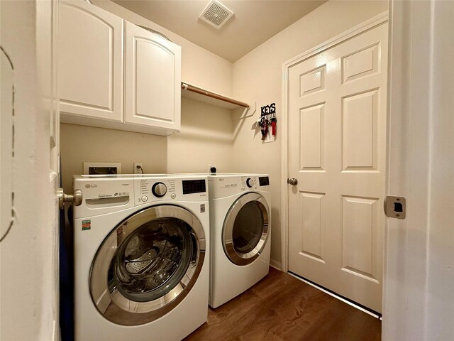 913 S Belle Dr, Angleton, TX 77515 - laundry area featuring washing machine and clothes dryer, cabinet space, and dark wood-style floors