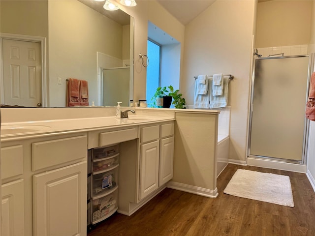 913 S Belle Dr, Angleton, TX 77515 - bathroom featuring a shower stall, double vanity, wood finished floors, and a bath