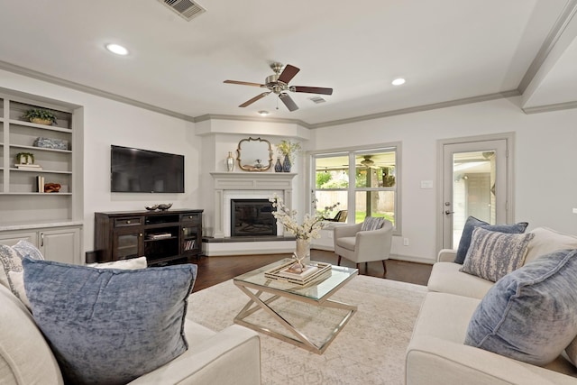 5743 Braesheather Dr, Houston, TX 77096 - living room with a ceiling fan, crown molding, dark wood-style floors, a glass covered fireplace, and recessed lighting