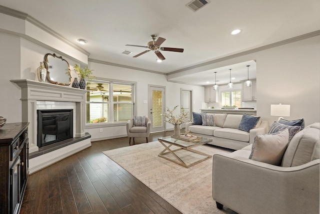 5743 Braesheather Dr, Houston, TX 77096 - living room featuring a ceiling fan, a glass covered fireplace, dark wood finished floors, recessed lighting, and ornamental molding