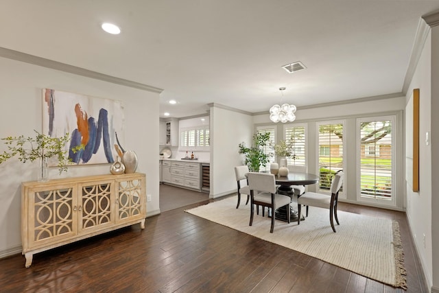 5743 Braesheather Dr, Houston, TX 77096 - dining area featuring crown molding, a chandelier, beverage cooler, recessed lighting, and dark wood finished floors